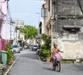 A woman biking on street in Penang, Malaysia