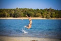 Woman in bikini on the beach jumping under water Royalty Free Stock Photo