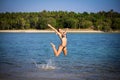 Woman in bikini on the beach jumping under water Royalty Free Stock Photo