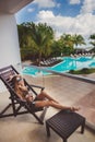 Woman in bikini drinking a cocktail on the terrace