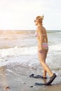 Woman in bikini with flippers and goggles on the beach Royalty Free Stock Photo