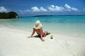 Woman in bikini and hat relaxing on the sea coast of Maldives Royalty Free Stock Photo