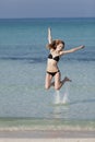 Woman with bikini jumping in the sea hochformat Royalty Free Stock Photo