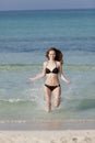 Woman with bikini jumping in the sea hochformat Royalty Free Stock Photo