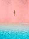 Woman lying on pink beach with blue sea in Komodo national park Royalty Free Stock Photo