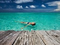 Woman in bikini lying on water Royalty Free Stock Photo