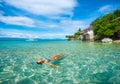 Woman in bikini relaxing lying on water against background of be Royalty Free Stock Photo