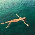 Woman in bikini relaxing lying on the water Royalty Free Stock Photo