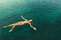 Woman in bikini relaxing lying on the water Royalty Free Stock Photo