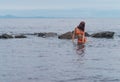 Woman in a bikini in the sea.