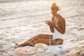 Woman in Bikini with a Smartphone and Headphones on the Beach Royalty Free Stock Photo