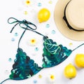 Woman bikini swimsuit with straw hat, flowers and fruits, flat design, copy space. Travel concept Royalty Free Stock Photo