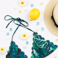 Woman bikini swimsuit with straw hat, flowers and fruits, flat design, copy space. Travel concept Royalty Free Stock Photo