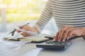 Woman with bills and calculator. Woman using calculator to calculate bills at the table in office. Calculation of costs. Royalty Free Stock Photo