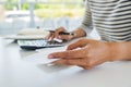 Woman with bills and calculator. Woman using calculator to calculate bills at the table in office. Calculation of costs. Royalty Free Stock Photo