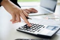 Woman with bills and calculator. Woman using calculator to calculate bills at the table in office. Calculation of costs. Royalty Free Stock Photo