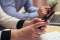 Woman with bills and smart phone at the table