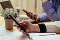 Woman with bills and smart phone at the table