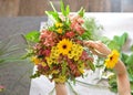 Woman binds flower bouquet in florist