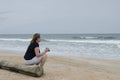 Woman with binoculars on beach 2