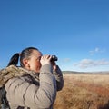 Woman with binoculars birdwatching