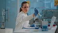 Woman biologist using micro pipette with test tube and beaker Royalty Free Stock Photo