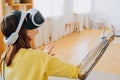 Woman with bionic arm and VR headset plays game in room