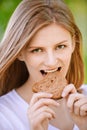 Woman bites piece of bread