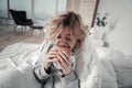 Woman biting burger while eating too much in depression Royalty Free Stock Photo