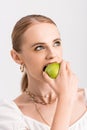 Woman biting green apple and looking Royalty Free Stock Photo