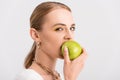 Woman biting green apple and looking Royalty Free Stock Photo
