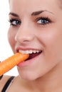 Woman biting raw carrot Royalty Free Stock Photo