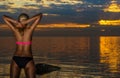 woman in black bikini posing on a sand rocks Royalty Free Stock Photo