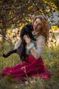 Victorian style, woman at autumn garden with a cat Royalty Free Stock Photo