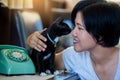 Woman and black cat sitting with Retro rotary telephone on wooden table Royalty Free Stock Photo