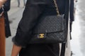 Woman with black Chanel leather bag before Wunderkind fashion show, Milan Fashion Week street style on