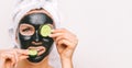 Woman with black charcoal facial mask. Mask for skin care, spa salon. Copy space Royalty Free Stock Photo
