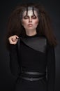 Woman in black clothes with expressive dark makeup