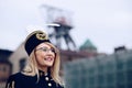 Woman in black coal miner foreman gala uniform with white feather on hat. Royalty Free Stock Photo