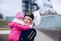 Woman in black coal miner gala uniform with her child. Royalty Free Stock Photo