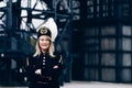 Woman in black coal miner supervisor gala uniform with white feather on hat.