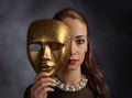 Woman in a black dress with a pearl necklace and old mask Royalty Free Stock Photo