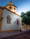 woman in a black dress, praying on her knees in the middle of the street, praying outside a Catholic church. Church of the