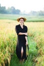 Woman in black dress and straw hat. Royalty Free Stock Photo