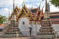 Woman with black dress and umbrella inside of buddah Wat Arun temple in Bangkok, Thailand, 13.08.2017.