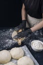 Woman in black gloves rolling out yeast dough with a rolling pin. Process of making bakery. Adjarian Khachapuri Recipe Ã¢â¬â Royalty Free Stock Photo