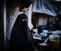 Woman in black hijab inside the Al-Hol camp.