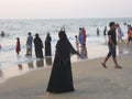 Woman in black on Indian beach