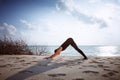 woman in black jumpsuit doing yoga Sun salutation Surya Namaskar