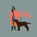 Woman with black Labrador dog on leash. Autumn walk